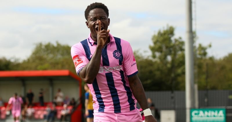 player wearing dulwich hamlet 2023-24 home shirt in pink and blue stripes